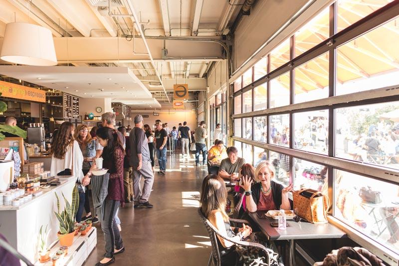 Visitors dining inside Union Market food hall in Washington DC.